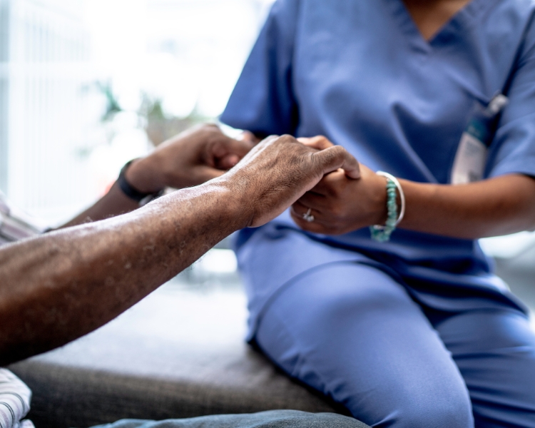 Nurse holding patients' hands