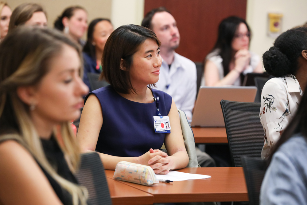 Duke School of Nursing Students sit in a classroom eagerly watching a presentation