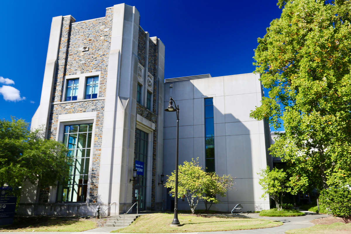 Duke University School of Nursing's exterior boasts the Duke bricks and ample space for students to study with lofty and grand arches.