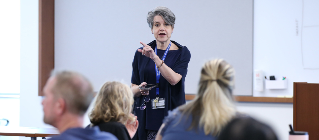 School of Nursing instructor in classroom with PhD students