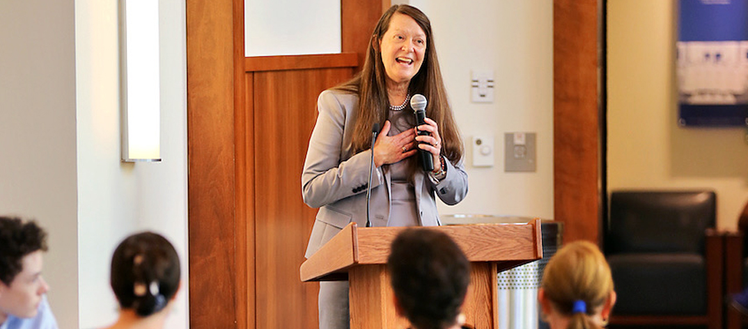 School of Nursing Faculty Member giving a speech to an audience.