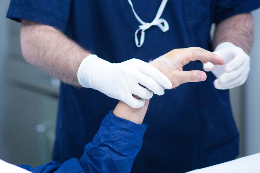 Orthopedic Nurse examining a patient's wrist