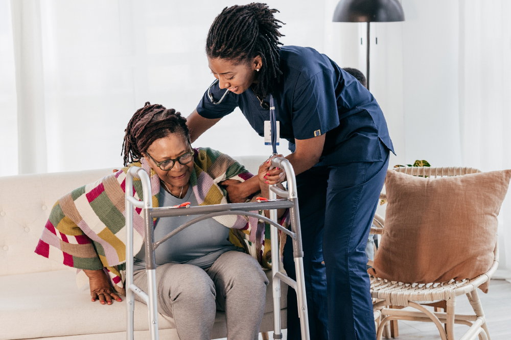 Palliative Care Nurse helping patient to stand