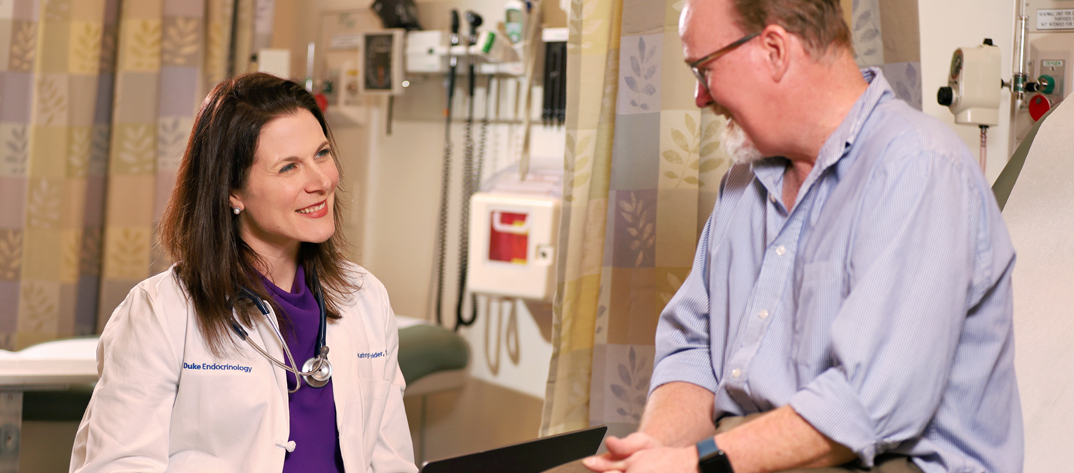 Endocrinology Nurse working with a patient sitting on a bed