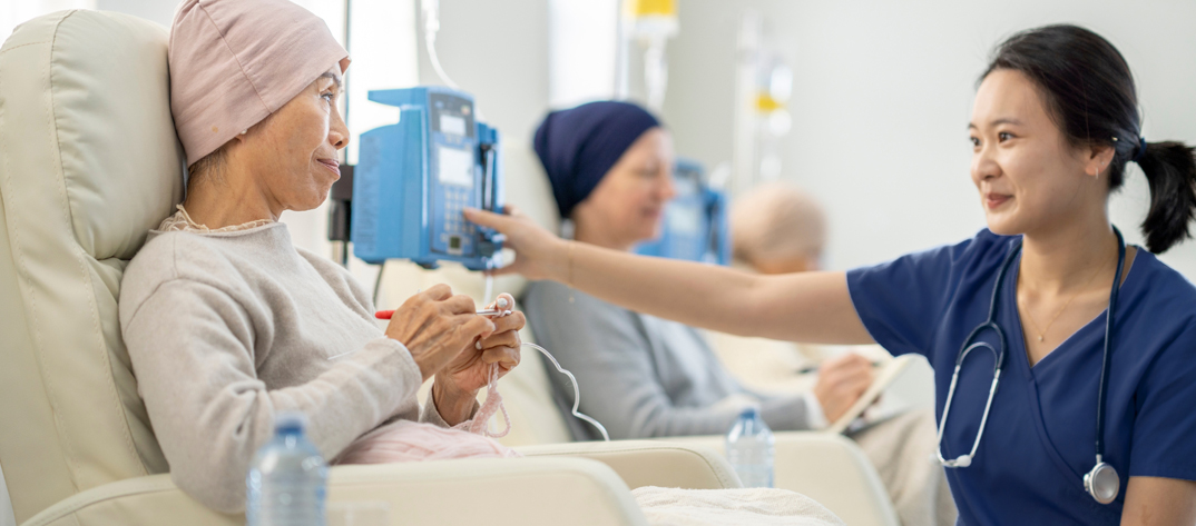 Nurse helping oncology patient with treatment 