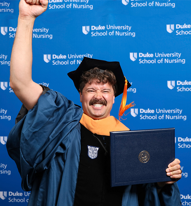 School of Nursing Graduate with a fist pump