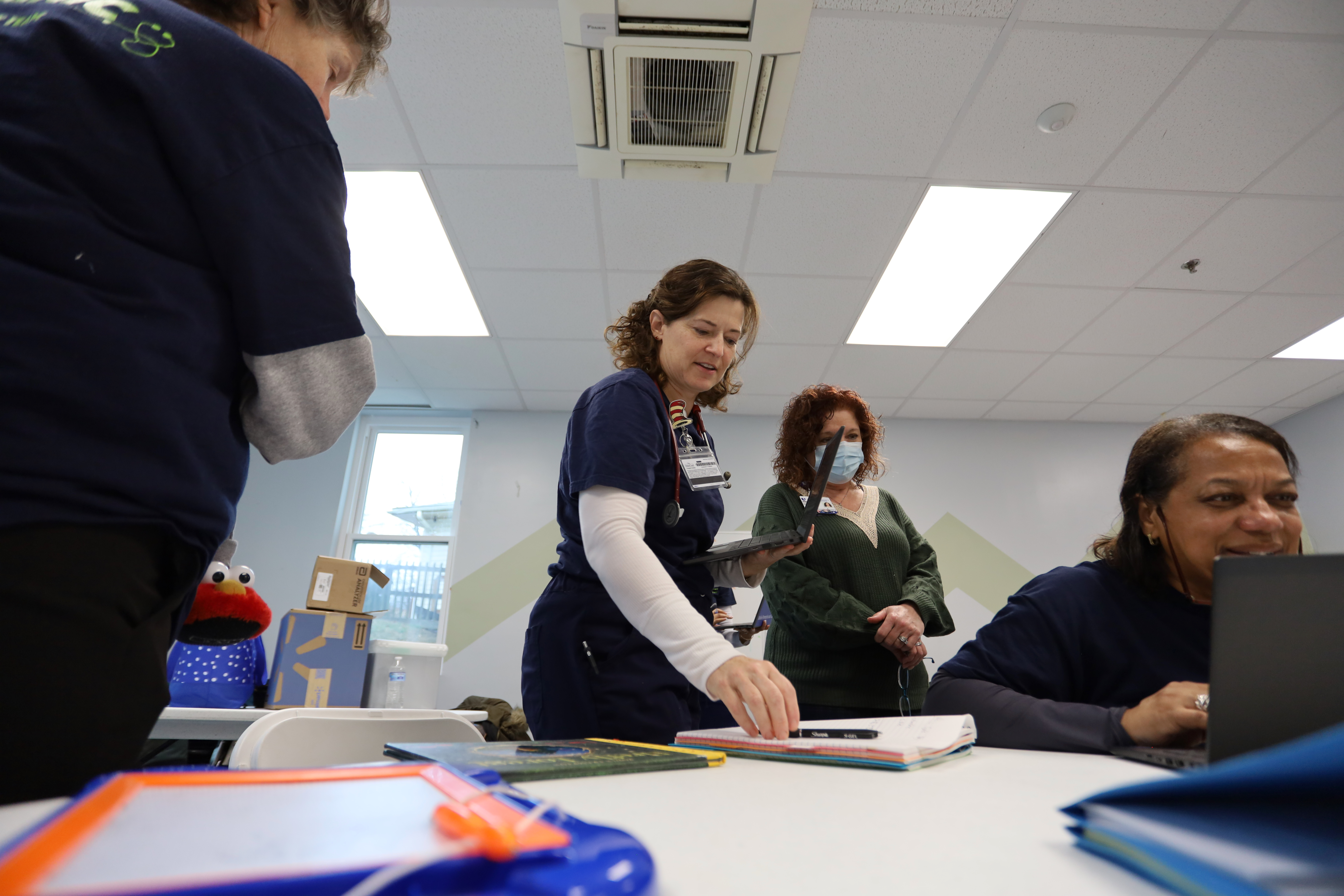 M-PACT Nurse talking over a computer