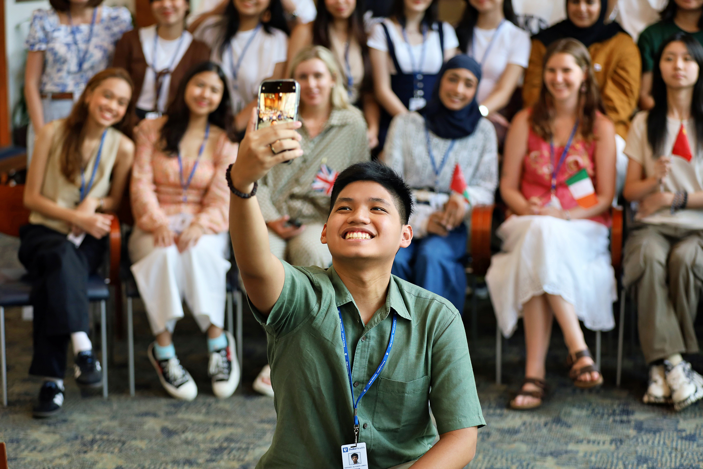 Male student taking a selfiee in front of the OGACHI Group