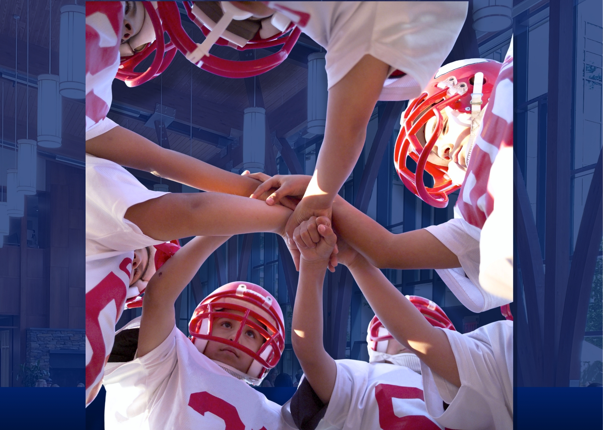 Stock image of youth in American football gear in a huddle