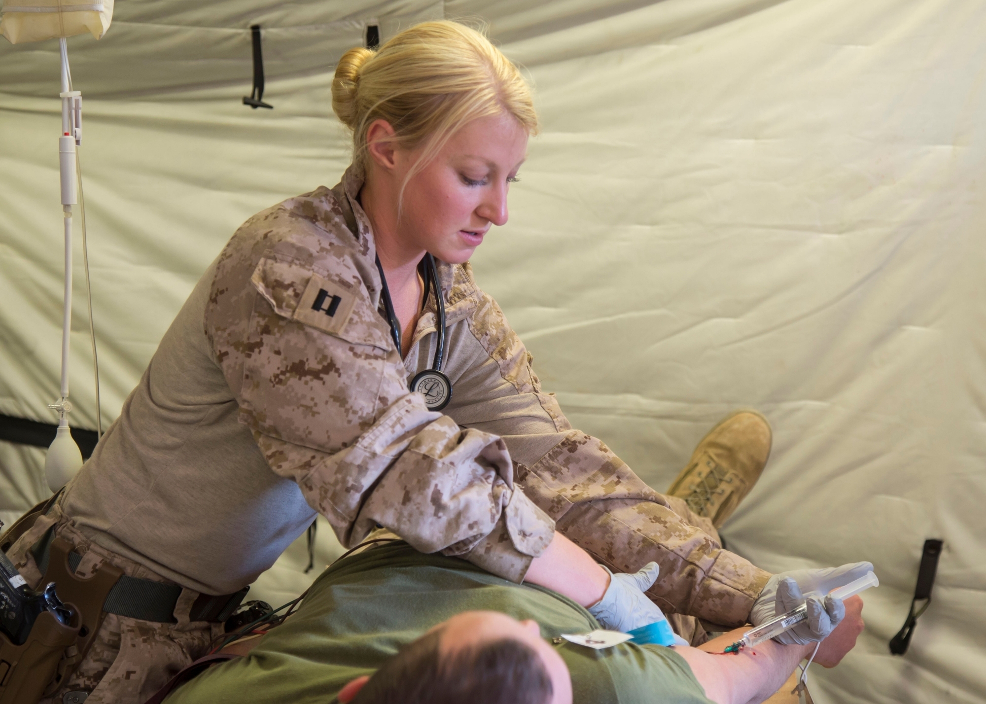 Erika Grattidge attends to a patient while an active military duty