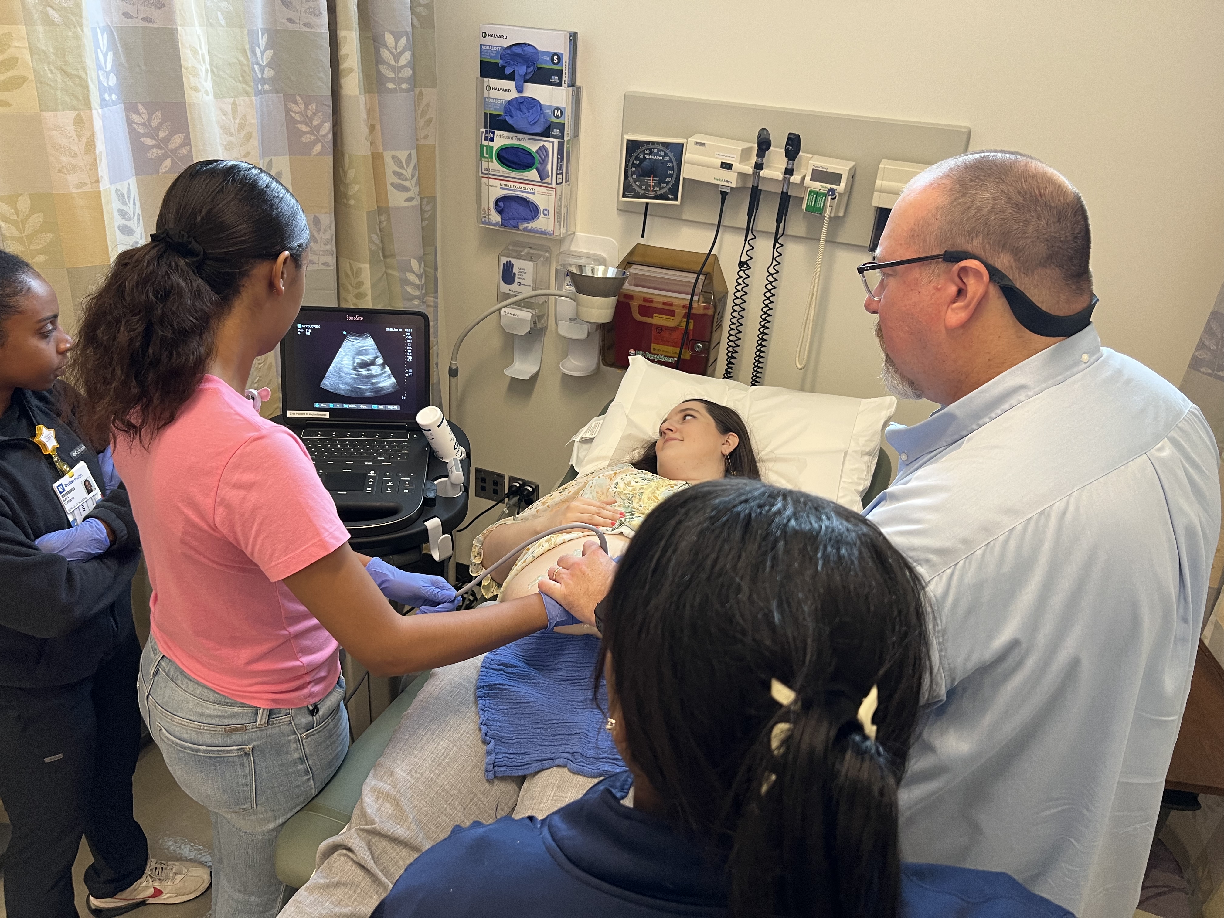 A practiced technician trains students in giving an ultrasound