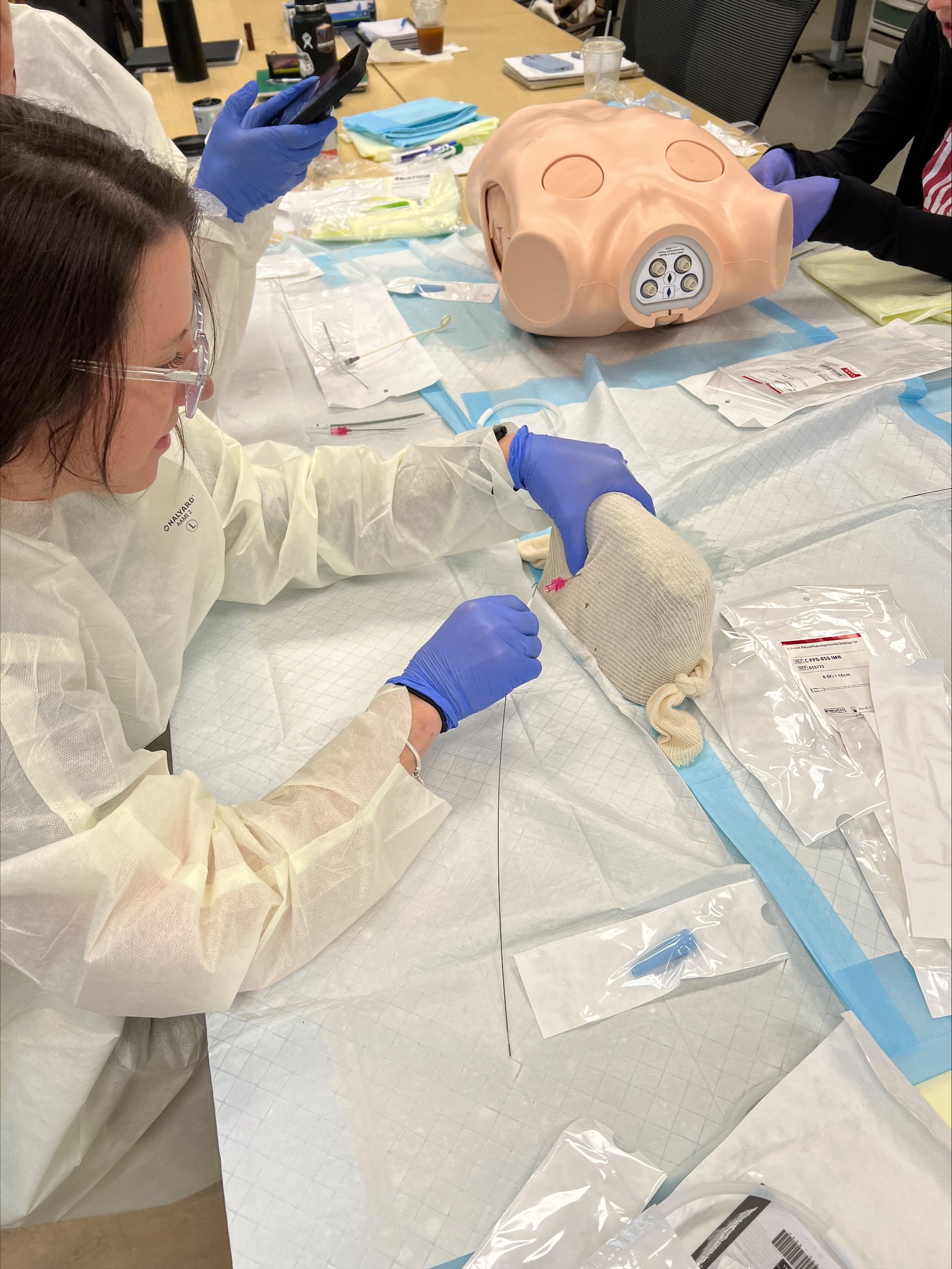 School of Nursing student practices a laceration repair procedure during an on-campus intensive
