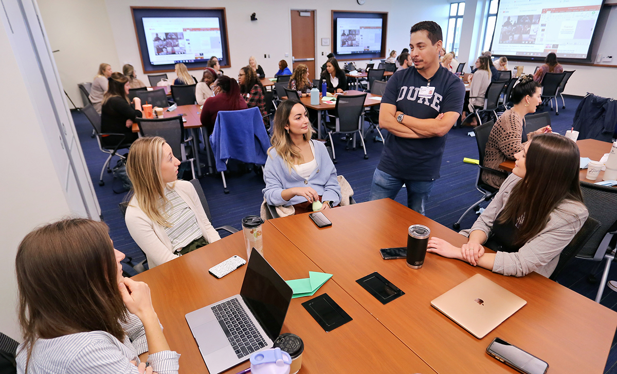 Nursing Students around a table having a discussion