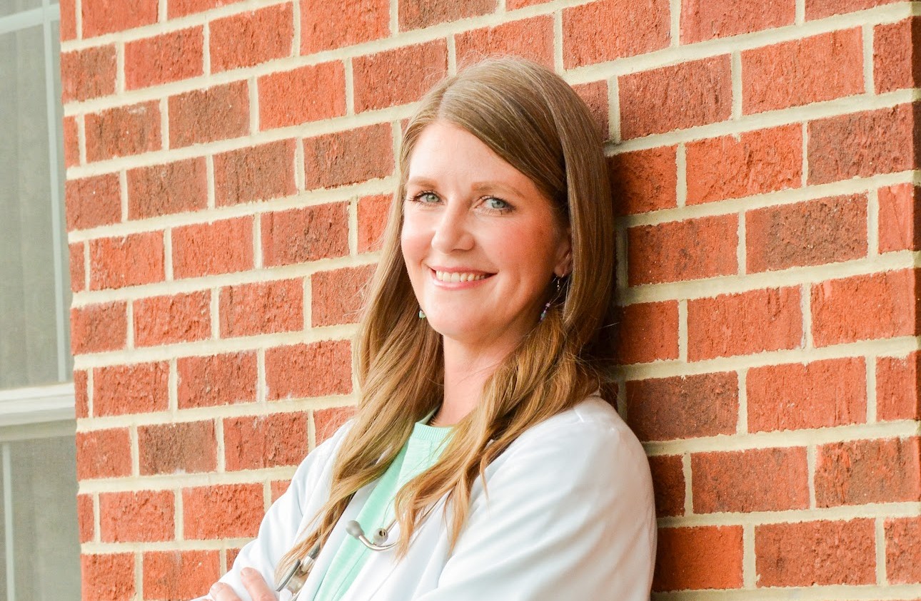 Shannon Allison leaning against a brick wall