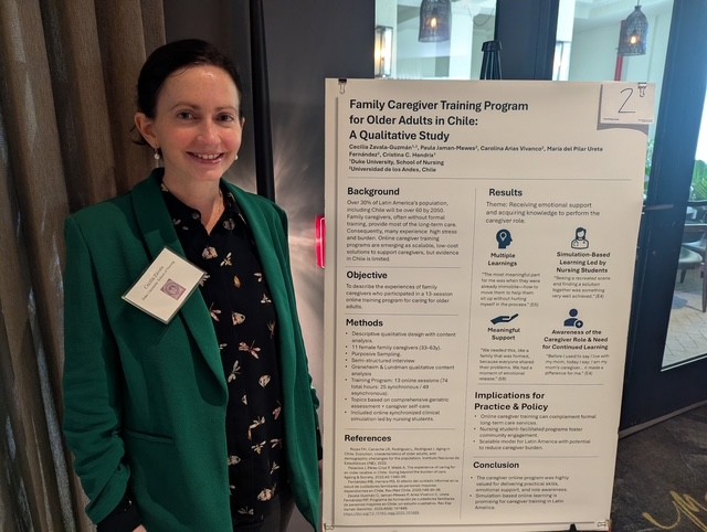 A student standing in front of a poster presentation at a conference.