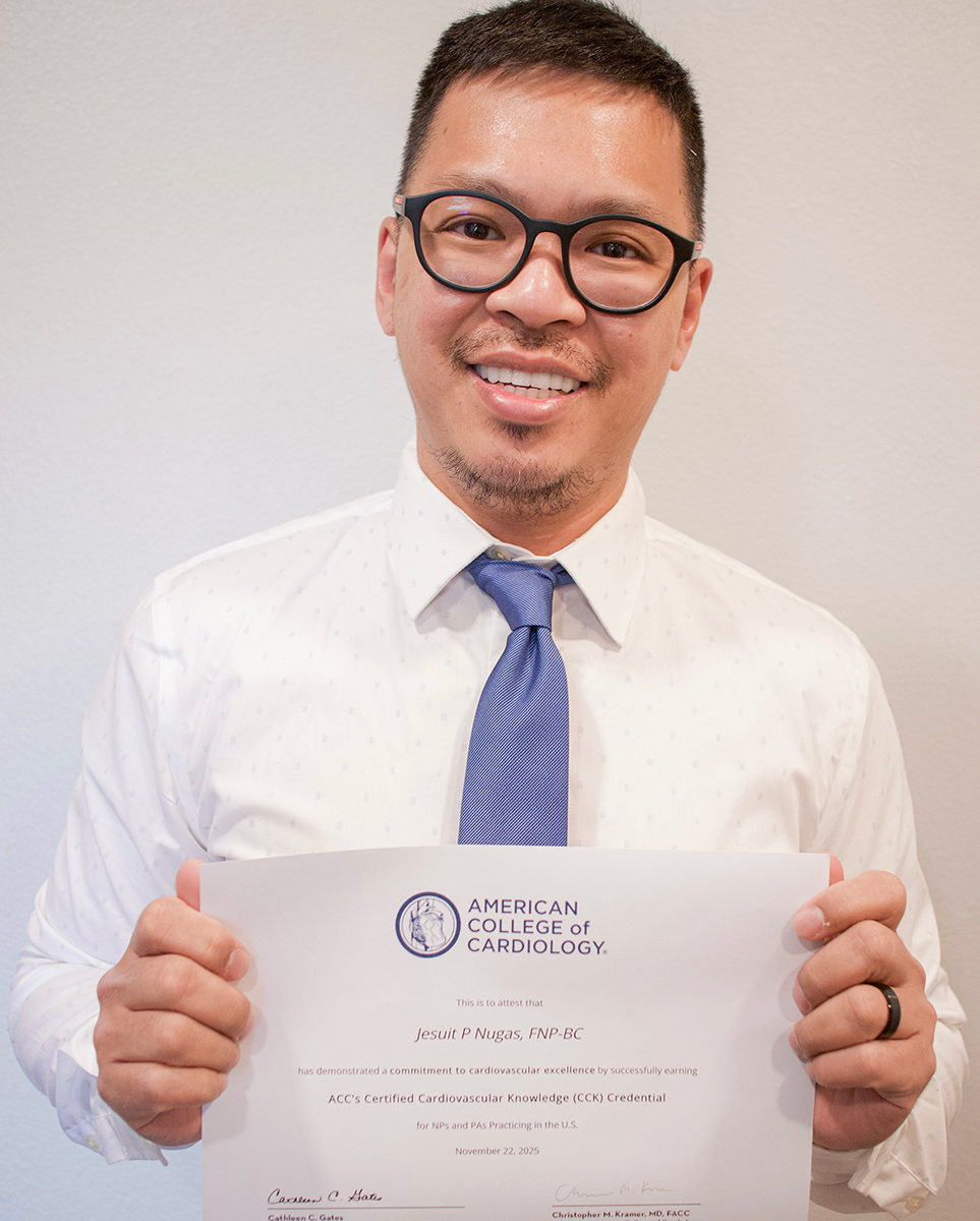 A man wearing a white shirt and blue tie holding up a certificate.