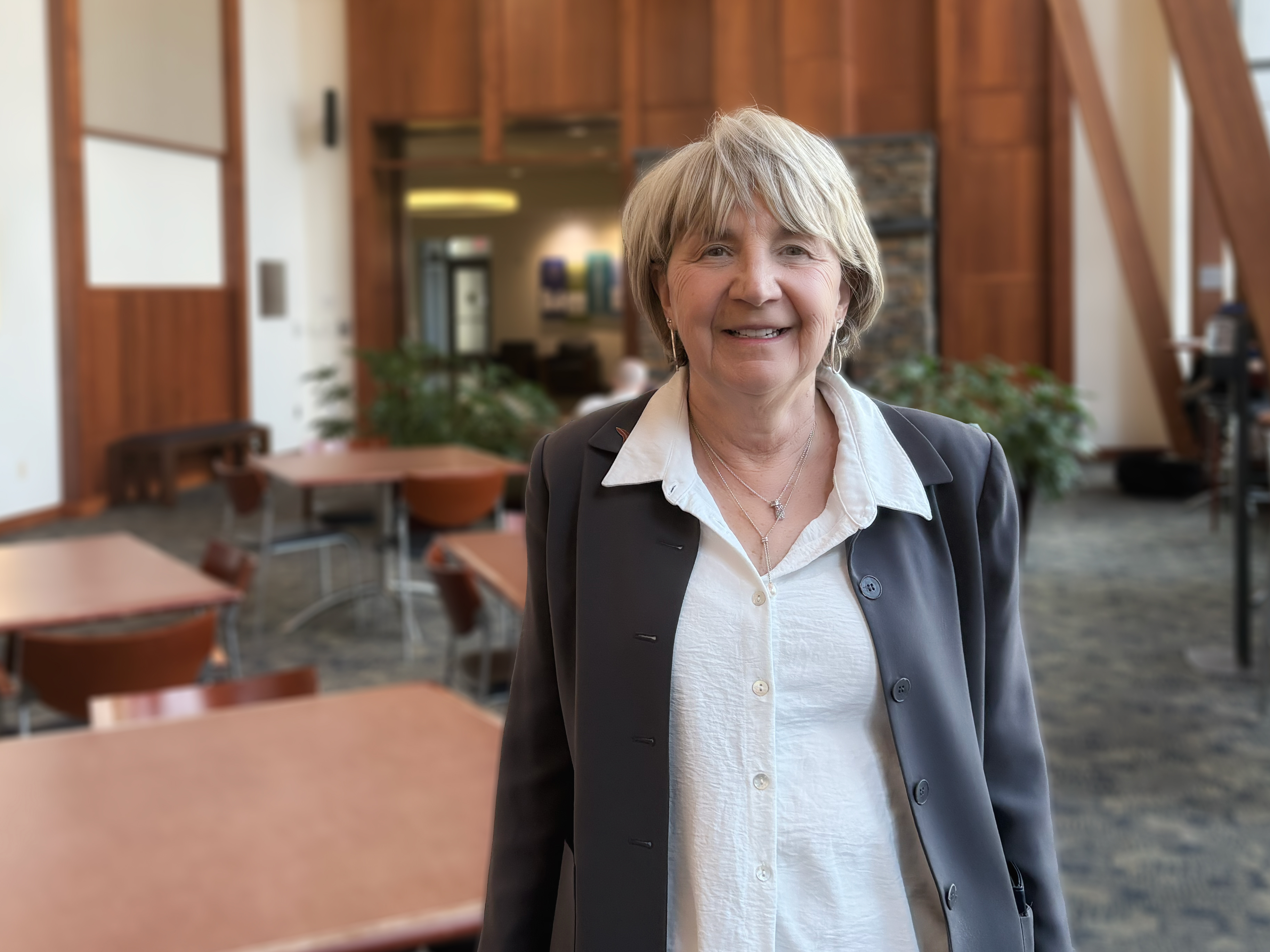 Paula Tanabe stands in the atrium of the Pearson Building