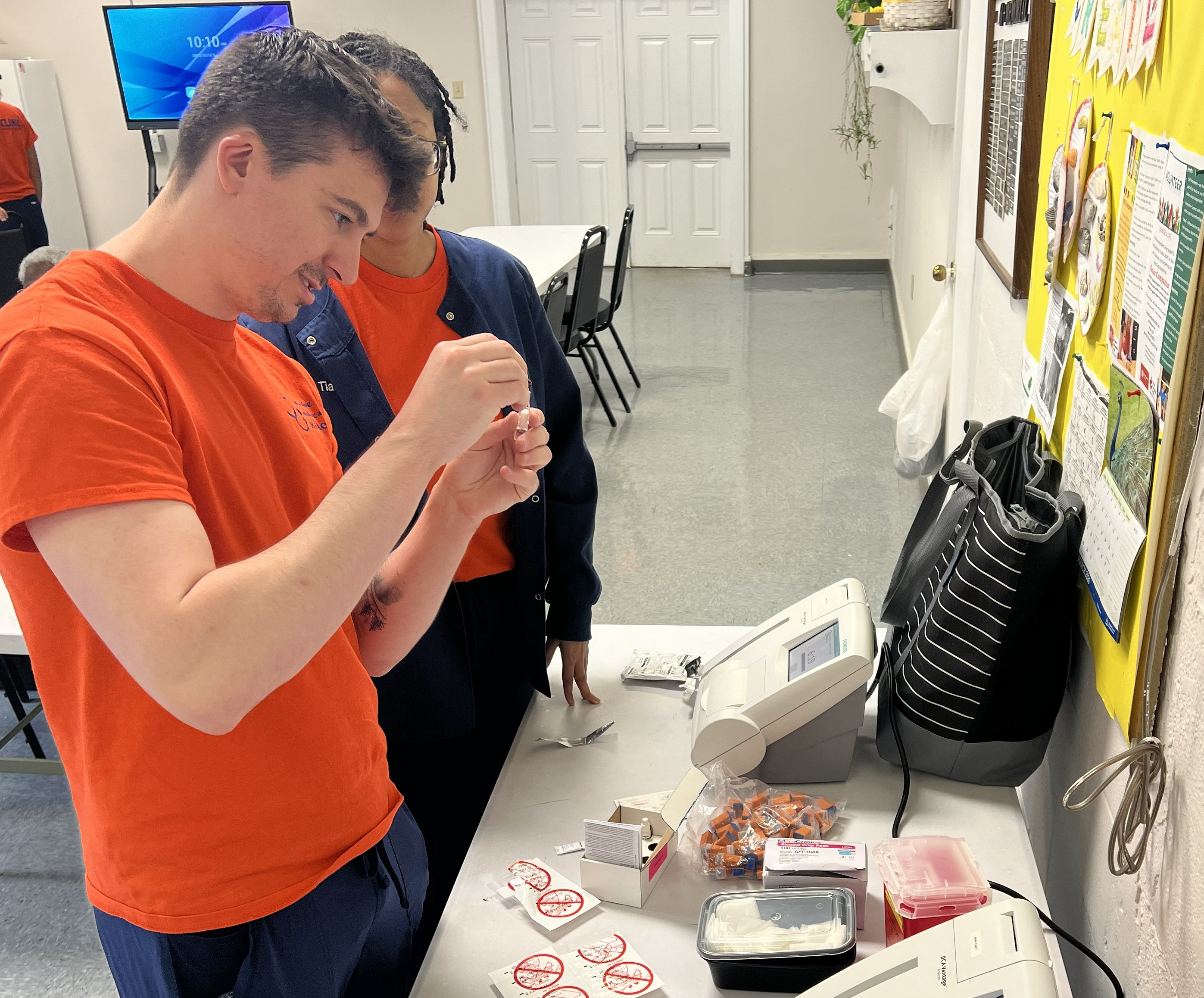 A Duke Nursing student checks A1C levels in a blood glucose reader