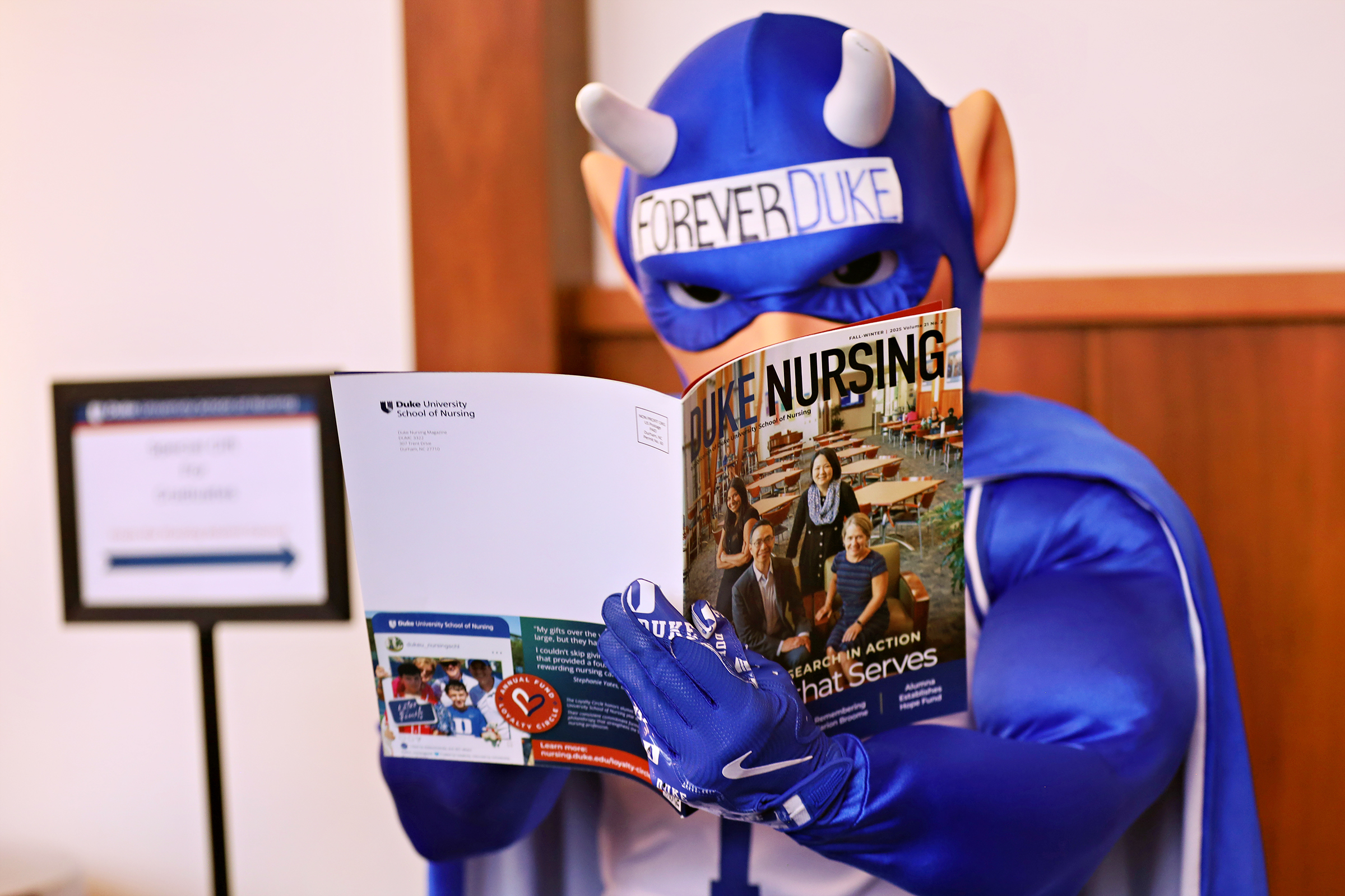 Duke Blue Devil reading Duke Nursing Magazine
