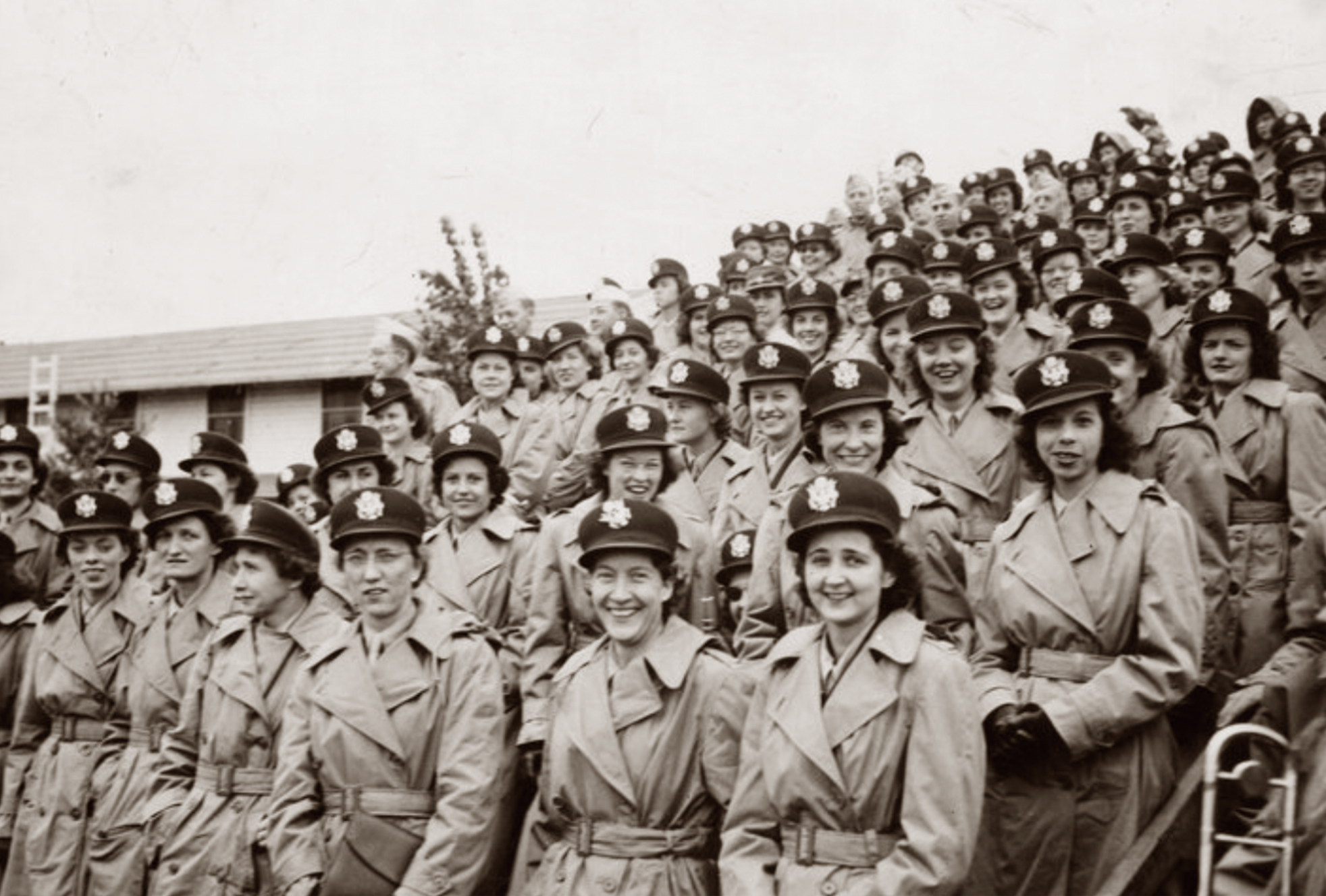A black and white photo of a group of women in military uniform during WWII.