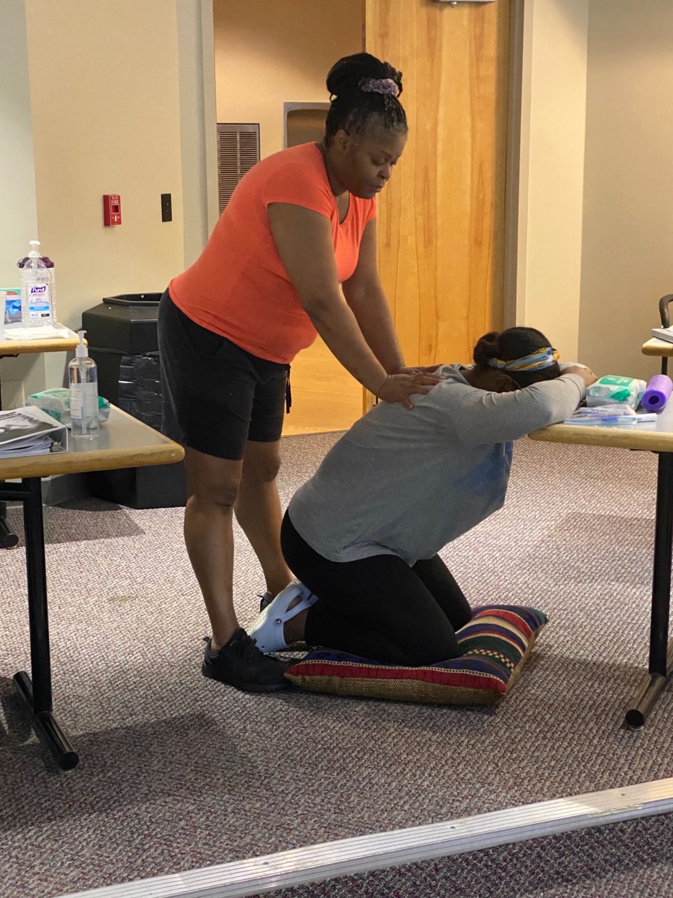 woman massaging other woman in doula training