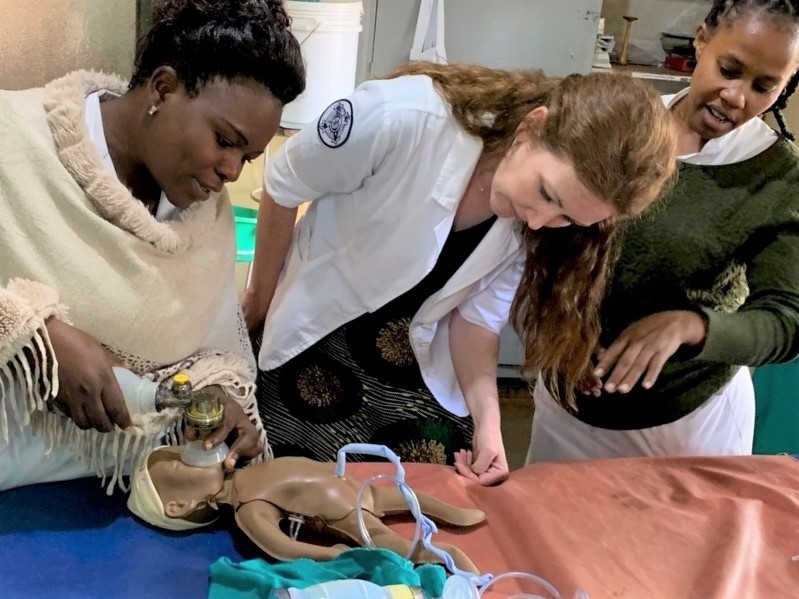 pami ellis with two other women demonstrating a procedure using a manikin baby