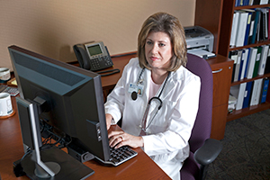 Care coordinator working at computer