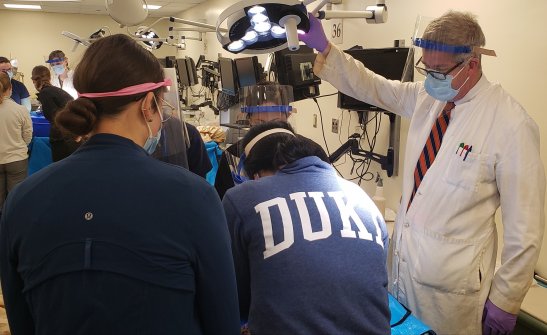 male doctor showing process to students