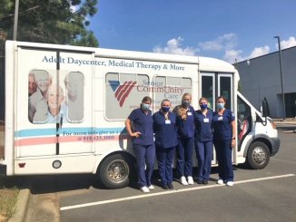 students stand in front of pace bus