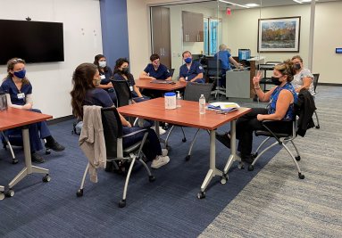 group of absn students sitting listening to instructor