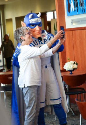 Alumni taking photo with Duke Blue Devil