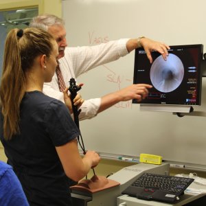 Professor working with student in simulation