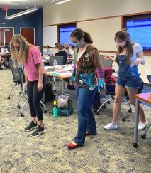 students with peas in shoe during class