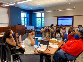 students sitting in group with sensory kit films