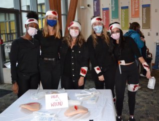 students dressed up around wound station