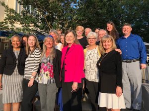 Barbara Turner surrounded by numerous colleagues outside the School of Nursing