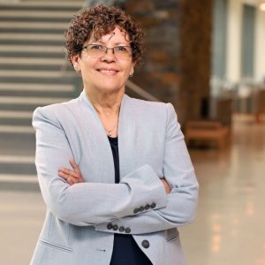 Associate Clinical Professor Dr. Iris Padilla standing in the lobby of the IPEC Building on Duke Campus