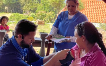 Christian Shepler taking a patient's blood pressure