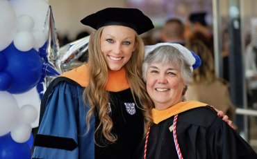 School of Nursing Gradaute with Professor