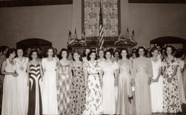 Nurses at a flag presentation at a party for members of the 65th General Hospital
