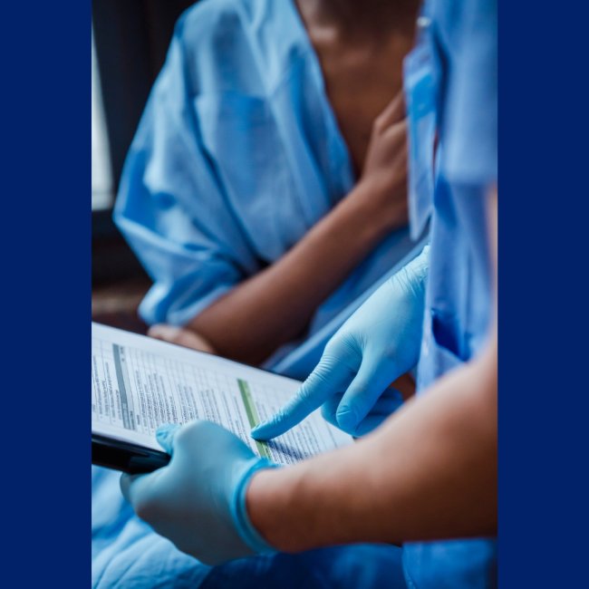 A nurse goes over a form with a patient