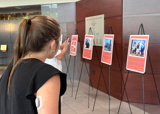 Community member engages with Photovoice exhibit