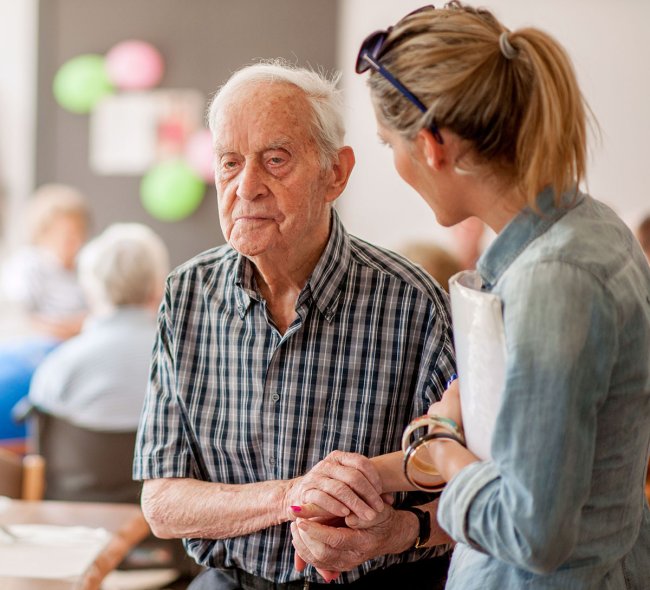 Student helping elderly man