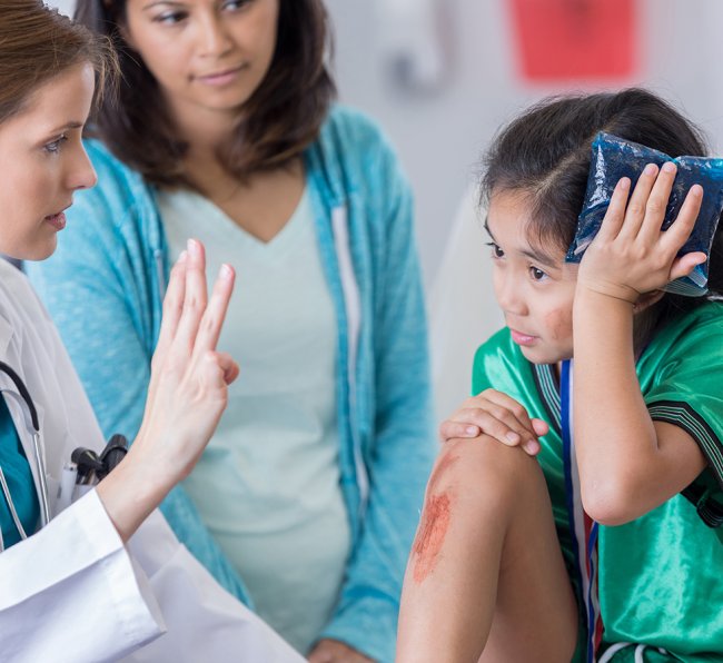 Little girl with head injury and scrapped knee