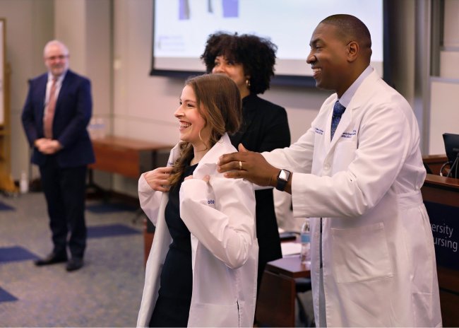 Derrick Glymph puts white coat on Duke University School of Nursing CRNA student