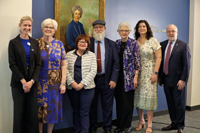 Duke University faculty and staff pose with relatives of Ruby L. Wilson in front of her portrait