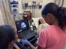 Nursing students giving ultrasound to volunteer