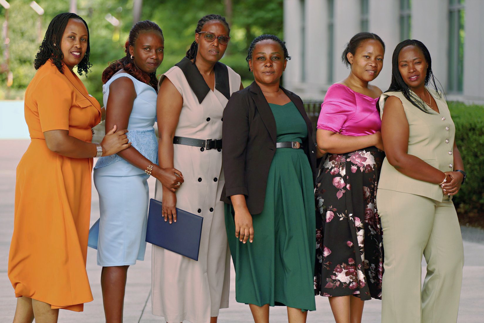 Six DNP graduates from Rwanda stand outside the Pearson Building