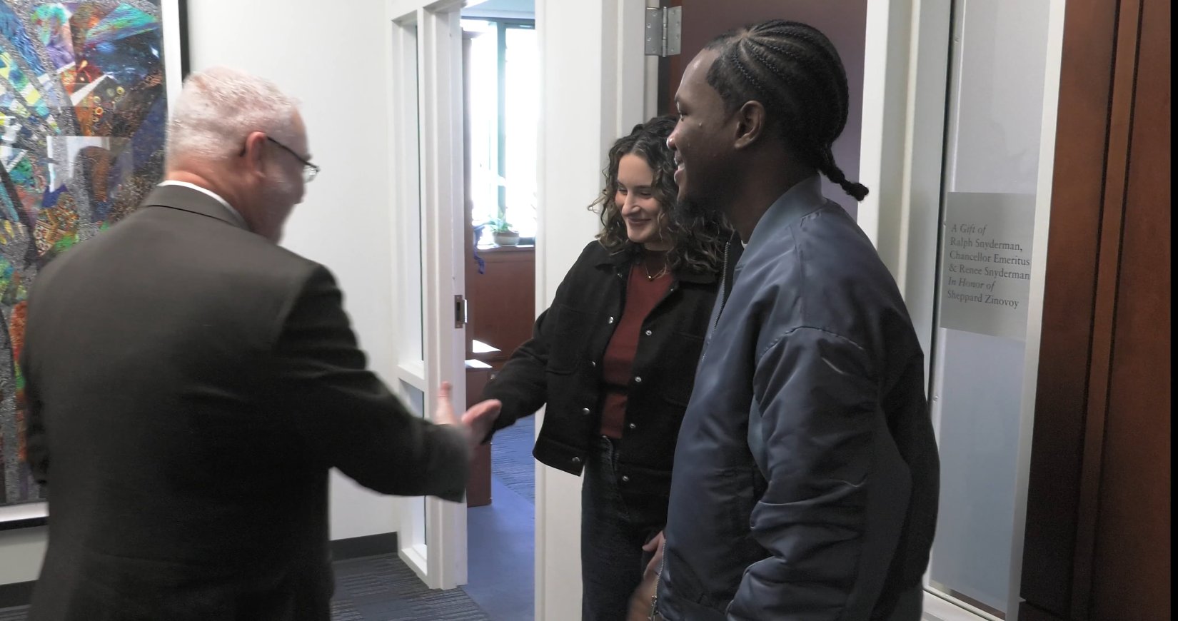 Dean Relf greets students McClear and Stepney