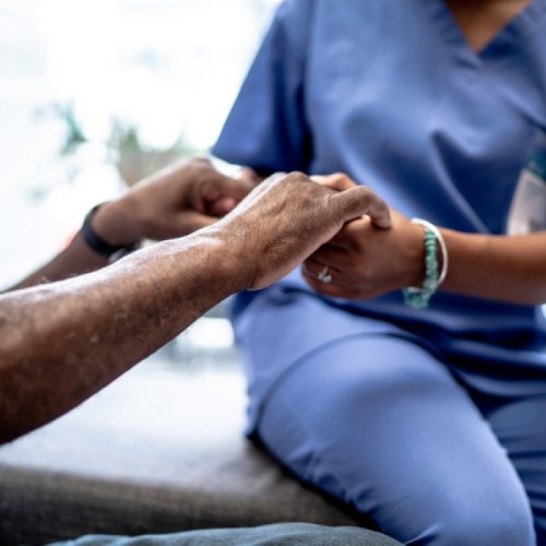 Nurse holding patients' hands